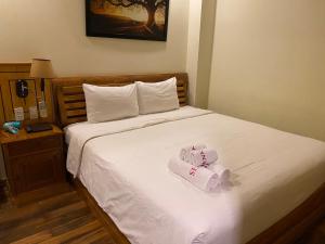 Postel nebo postele na pokoji v ubytování Senkotel Nha Trang Managed by NEST Group