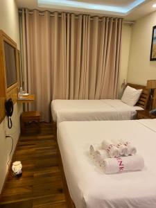 Postel nebo postele na pokoji v ubytování Senkotel Nha Trang Managed by NEST Group