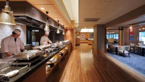 two chefs preparing food in a restaurant kitchen at Kamogawakan in Kamogawa