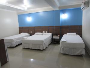 A bed or beds in a room at Tapajós Center Hotel