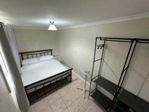 a small bedroom with a bed and a fan at Charming 3 bedroom Workers Accommodation in Grafton