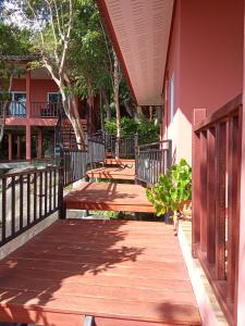 una pasarela de madera con bancos en un edificio en PawPaw Resort, en Koh Samui 