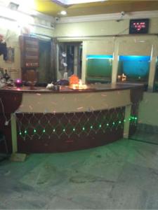 a bar in a room with green lights at Roxy Inn,Cuttack in Cuttack