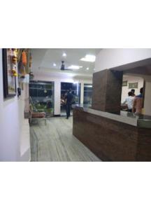 a lobby of a restaurant with people sitting at a counter at Shri Jagannath Hotel,Cuttack in Cuttack