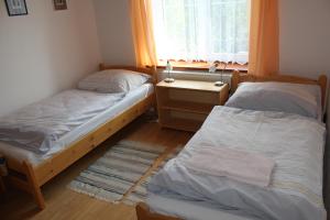 En eller flere senge i et værelse på Penzion Mühl