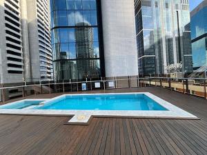 a swimming pool on the roof of a building at Location Location Executive Apartment in Sydney