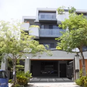 a building with two potted trees in front of it at WiSmart in Taichung