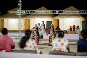 a group of people watching a presentation at a performance at The Taj of Desert in Sām