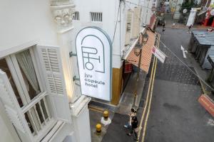 an overhead view of a sign on the side of a building at Jyu Capsule Hotel in Singapore
