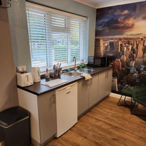 a kitchen with a sink and a large window at The Golf Studio Woodhall Spa in Woodhall Spa