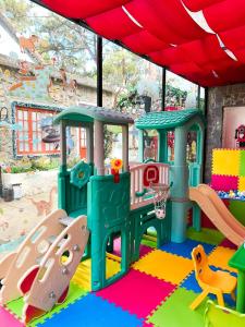 a childrens play area with a playground at De Vivre Homestay Măng Đen in Kon Von Kla