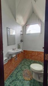 a bathroom with a toilet and a sink at KALAYAAN INN in Port Barton