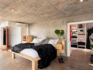 a bedroom with a large bed with a black blanket at Milner Fashion House in Pretoria +29 photos