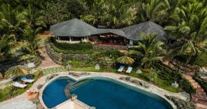 an aerial view of a resort with a swimming pool at ama Stays & Trails Eden Farms Sapphire, Goa in Goa