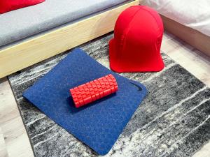 a red cap and a toy red calculator on a rug at MAT WASEDA in Tokyo