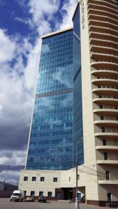 a large glass building with cars parked in front of it at SK Royal Hotel Moscow in Moscow