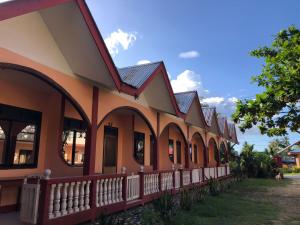 a row of houses with red roofs at JBR Tourist Inn - Port Barton in Itaytay