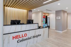 a hotel lobby with a hello colo colonial hospitals sign at TownePlace Suites by Marriott Richmond Colonial Heights in Colonial Heights