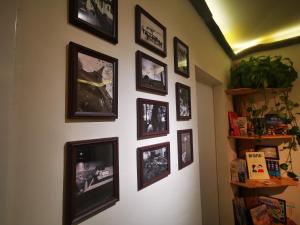 a wall with a bunch of pictures on it at 此时此刻民宿This Moment B&B in Miyun