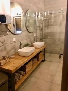 a bathroom with two sinks and two mirrors at Chalet Blanc in Kolašin +7 photos