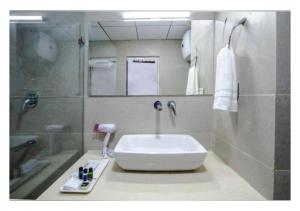 a bathroom with a sink and a shower at La Serene Valley Resort By DLS Hotels in Manāli