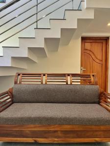a bench in a room with a staircase at BAVA Lalitha Retreat Center Varkala in Varkala