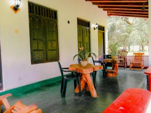 a room with a table and chairs and doors at Banana Rest Sigiriya in Sigiriya