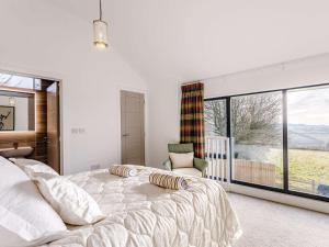 a bedroom with a large bed and a large window at 1 Bed in Combe Martin 77349 in Loxhore