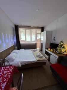 a bedroom with a bed and a christmas tree in it at Apartment in Bakuriani in Bakuriani