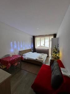 a bedroom with a christmas tree and a bed and a table at Apartment in Bakuriani in Bakuriani