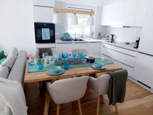 a kitchen with a table with blue dishes on it at Eni-Time Mariazell in Mariazell