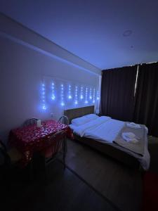 a bedroom with a bed with lights on the wall at Apartment in Bakuriani in Bakuriani
