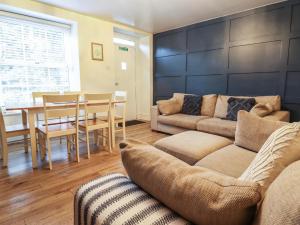 a living room with a couch and a table at Gwel Y Môr in Beaumaris +23 photos