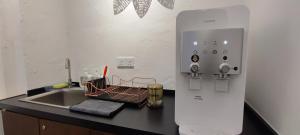 a kitchen counter with a sink and a refrigerator at TREASURE HUNTER At Heritage Georgetown in George Town