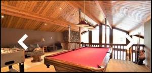 a large room with a pool table in it at WATERFRONT LUXURY HOUSE/CHALET in Ragged Rapids