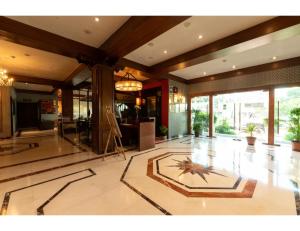 a lobby with a clock on the floor of a building at A Hotel, Ludhiana in Ludhiana