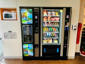 a black refrigerator with food and drinks in it at ibis budget Roye in Roye