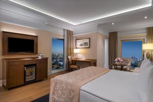 a hotel room with a bed and a television at Rotta Hotel Istanbul in Istanbul