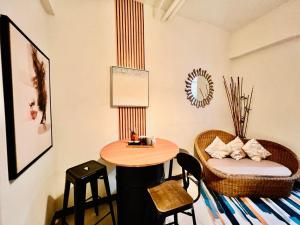 a room with a table and a small table and chairs at Tomas Morato Quezon City - Residences in Manila