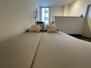 a large bed in a room with two pillows at Charmant Studio - Port de Nice in Nice
