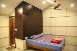 a bedroom with a bed with a black wall at Rainbow Residency in Yelagiri