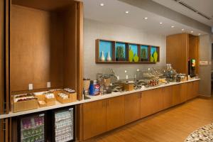 a large kitchen with wooden cabinets and a counter at SpringHill Suites Bridgeport Clarksburg in Bridgeport