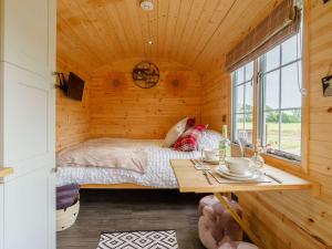 a bedroom with a bed in a wooden cabin at 1 bed in Stapleton 88970 