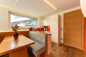 a kitchen with a table and a vase on the counter at Appartementhaus Leeder by Schladming-Appartements in Schladming