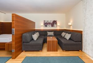 a living room with a couch and a bed at Appartementhaus Leeder by Schladming-Appartements in Schladming