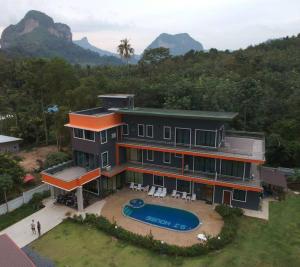 uma casa grande com uma piscina em frente em Sj House Hotel Aonang em Ban Khlong Haeng