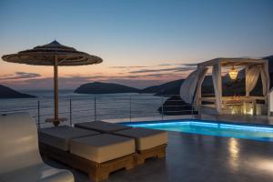 a house with a swimming pool and an umbrella at Sirius Villa Skalia in Skaliá