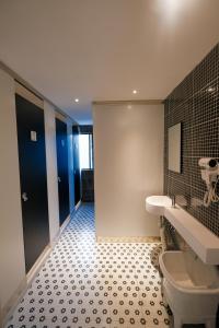 a bathroom with a toilet and a tiled floor at 不负韶华青年旅馆 Youth Hostel in Suzhou