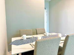 a room with a table with chairs and a mirror at SKS Pavillion Residence Suites by Luxecocoo CK Johor Bahru in Johor Bahru +172 photos
