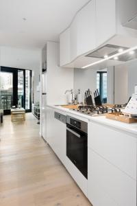 a kitchen with white counters and a stove top oven at City Lookout with Amenities in Melbourne